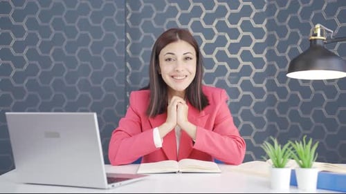 Young Woman Smiling at Desk