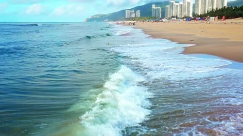 Aerial Top view of a transparent blue sea with beautiful waves at sunny day in summer. air of ocean