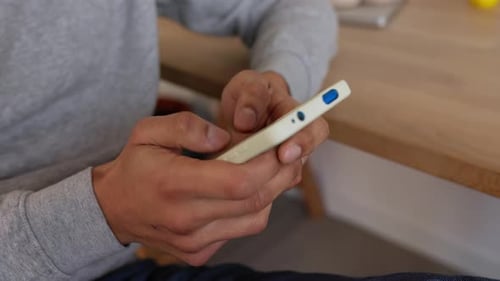Close Up View of Unrecognizable Male Hands Typing Message on Smartphone App