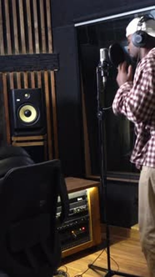 Singer recording music in professional studio