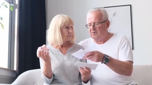 Senior Couple Reviewing Finances Together at Home