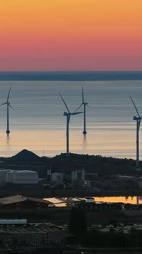 Aerial drone view of the Middelgrunden wind farm outside Copenhagen, Denmark at sunset. Vertical
