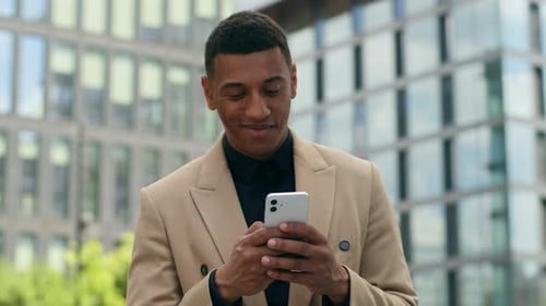 Man Using Smartphone on City Street