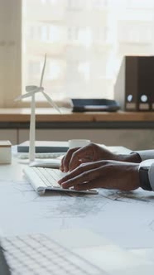 Black Male Engineer Working on Computer at Renewable Energy Company Office