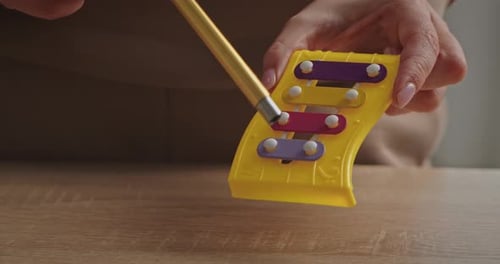 Playing a Colorful Toy Xylophone with Mallet