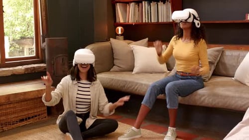 Two Young Women Experiencing Virtual Reality in Home