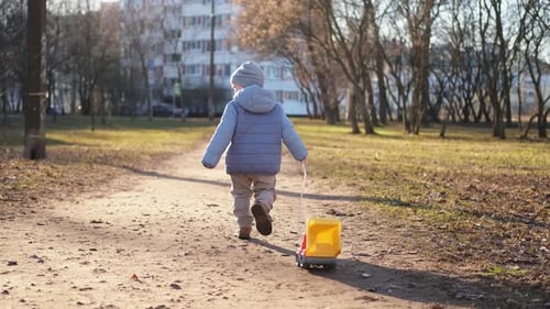Happy Baby Child Outdoor Little Toddler Boy with Toy Car Having Fun on Walk in Park Baby Son Smiling