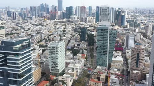 Aerial Shot Of Downtown District In Residential City, Drone Flying Forward Over Cars Moving On Road