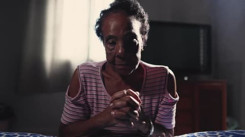 One Catholic Black Brazilian Senior Woman in Prayer, Making the Sign of the Cross in Spiritual