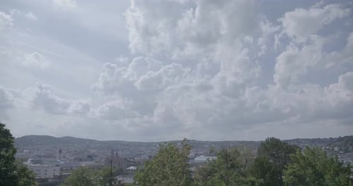 Pan across cloudy sky to skyline of Stuttgart, Germany