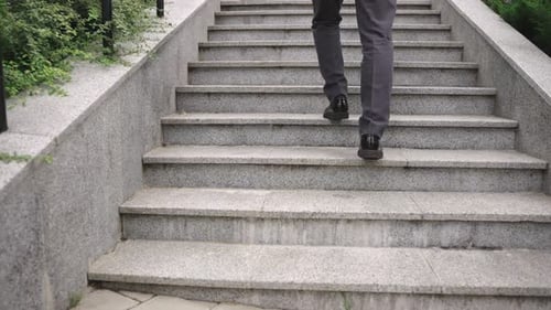 Modern Businessman Walking Up the Stairs in the City Slow Motion