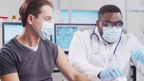 Doctor Gives Patient a Shot in Clinic Office