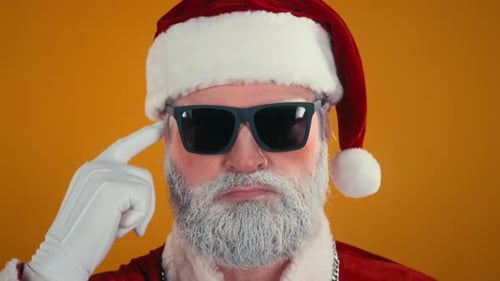 Funky Senior Man in Santa Claus Costume Rocking out to Upbeat Music