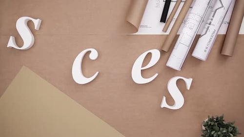 Teamwork hands building success word from white letters on office table