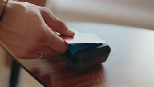 Person Making Contactless Payment with Credit Card