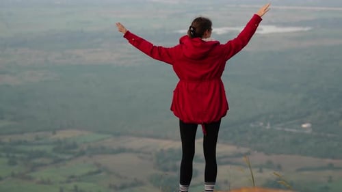 A Woman Walking on a Hill A Woman Standing on a Hill with Her Arms Outstretched Amidst the Untamed