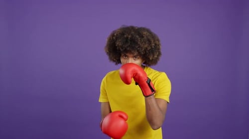 Man Practicing Boxing Punches in Yellow Shirt