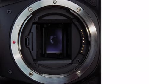 Shutter sound, inside mechanism of a digital camera body without the lens. Close up slomo of a mirro