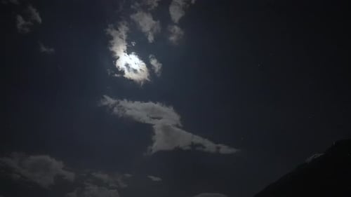 Zeitraffer des Sternenhimmels über Italien mit dem aufgehenden Mond und dem Berg im Vordergrund.