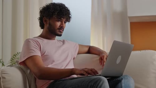 Slow Motion Young Smiling Man Typing Keyboard to Send Email on Laptop Funny Guy Distant Works While