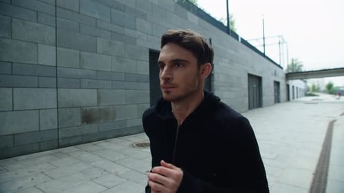 Closeup Fit Man Jogging At City Street In Slow Motion. Sexy Man Running Outdoors. Athlete Guy Tra...