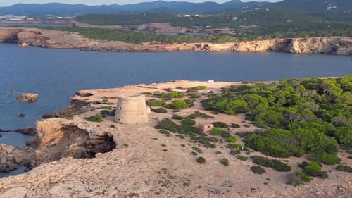 mediterranean coastal sunset ancient historic tower. Unbelievable aerial top view flight circle dron