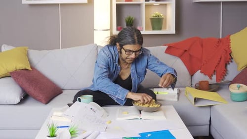 Stressed Person Working at Home Surrounded by Mess