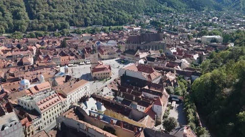 Close-up View of Powerful Waterfall Plunging Over Dark Cliff and Moss.