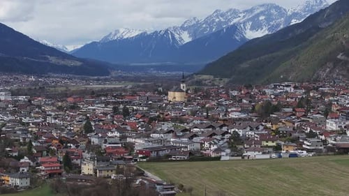 Aerial View of Alpine Town with Church Steeple and Snow Capped Peaks
