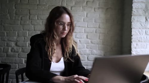 Young Woman Working on Her Laptop Computer in Coffee Shop