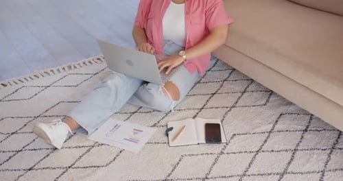 Woman Works on Laptop at Home on Rug