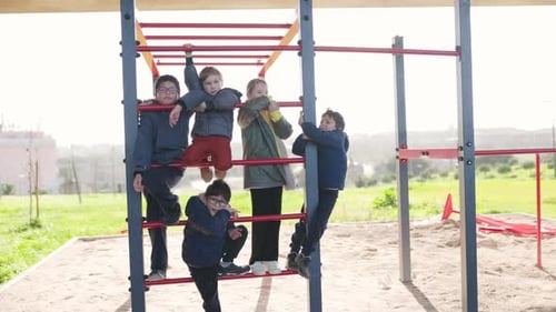 Group of Children Playing Together on Playground Monkey Bars