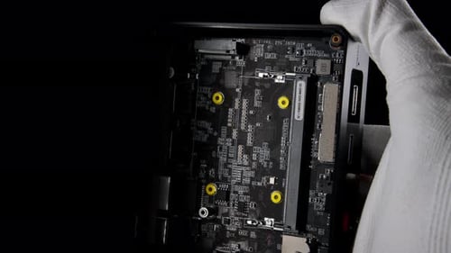 Inside Out Mini Computer Disassembly Revealing Memory Slots and SSD