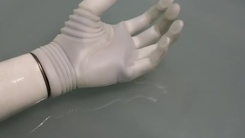 Futuristic White Prosthetic Arm Reaching Out