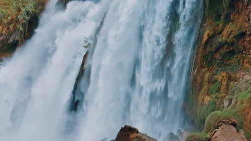 Powerful Waterfall Flowing Over Rocks in Nature