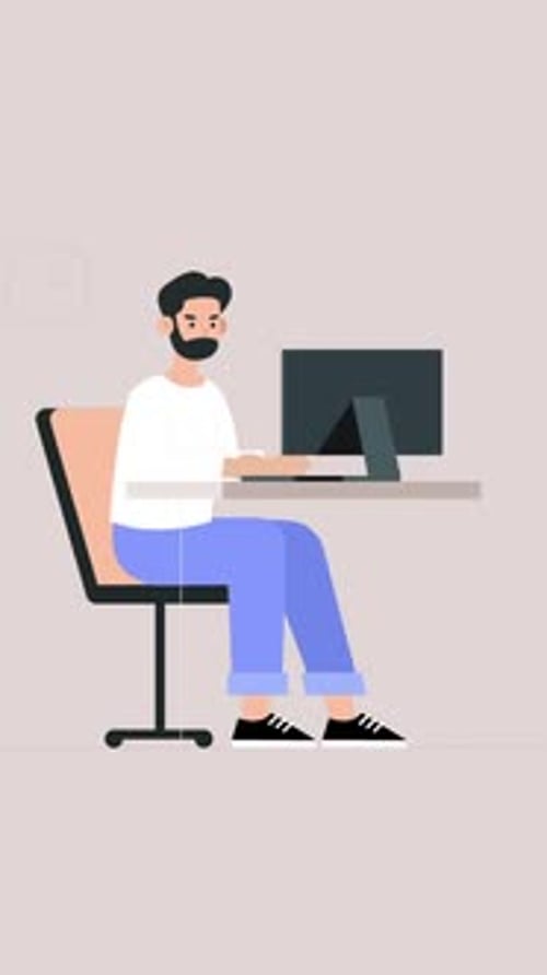 Bearded Male Employee Working in the Office Working on a Project on his Laptop Vertical