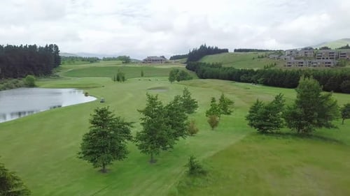 Aerial View Of A Golf Course With Green Lawn And Ponds