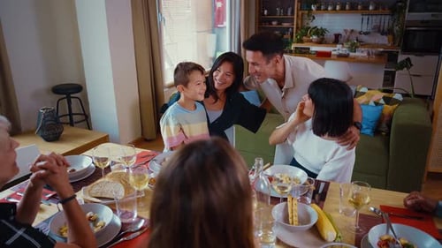 Diverse Family Sharing Meal and Smiling Indoors