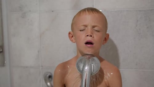 Child Enjoying Water from Shower Head
