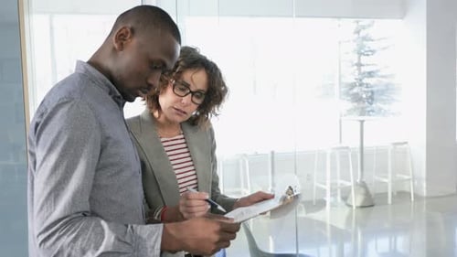 Business People Discussing Paperwork in Office 2529 Years