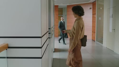 Female Office Worker Entering Elevator