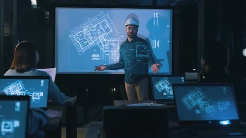 Architect Presents Blueprints to Team at Night