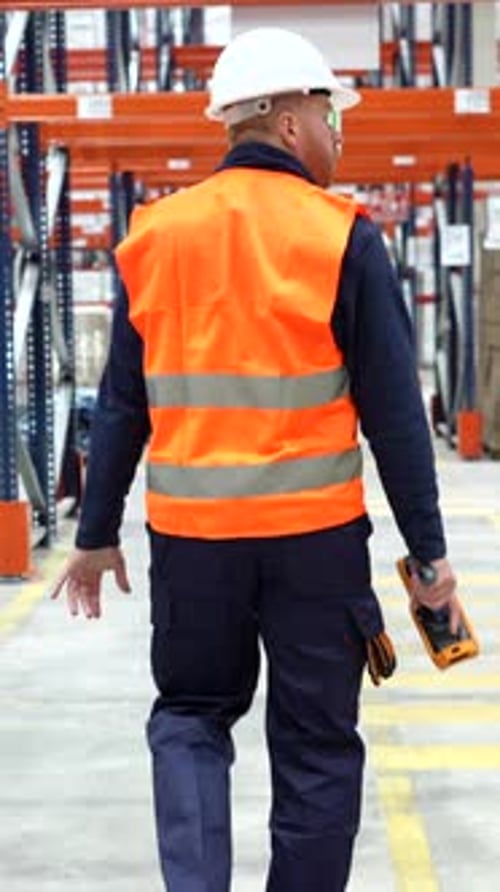 Warehouse worker walking through logistics center