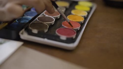 Hand Mixing Watercolor Paints with Brush at Home