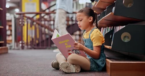 Reading book, learning or girl in a library for a story in school campus for education on bookshelf