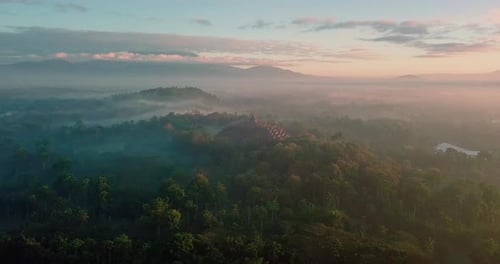 beautiful drone flight with view over the borobudur temple indonesia and the surrounding mountains i