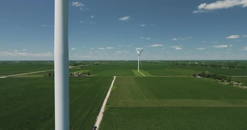 Wind Farm - Aerial View Of Green Fields, Crops, Road And Wind Turbines In The Countryside.
