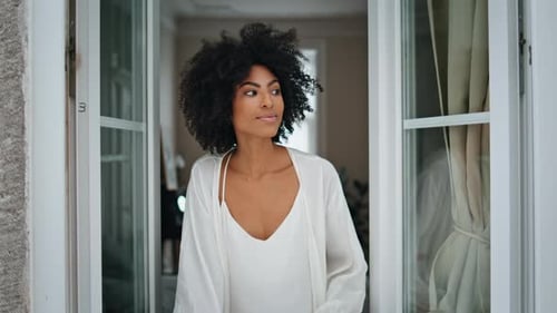 African Woman Peeping Window at Home Closeup
