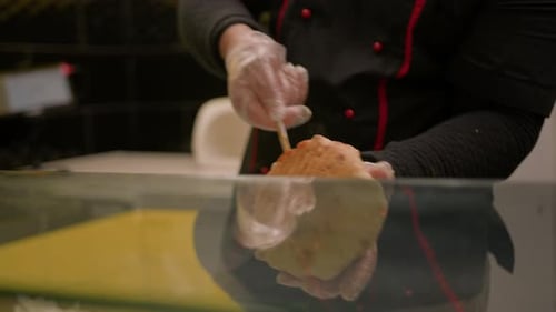 Chef making pita with roasted chicken meat on table - summer food market. Cooking, gastronomy