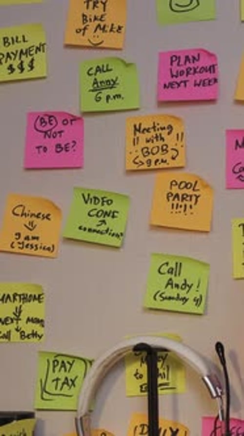Woman Uses Wall Notes to Organize Tasks